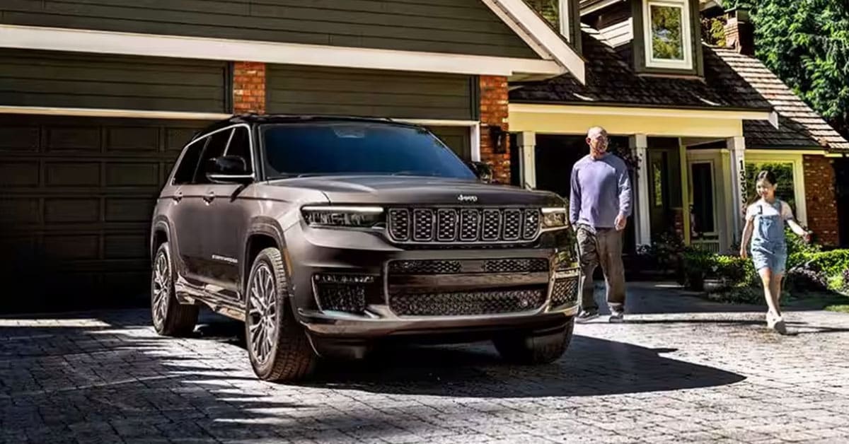 2025 Jeep Compass with Father with his daughter walking nearby.jpg