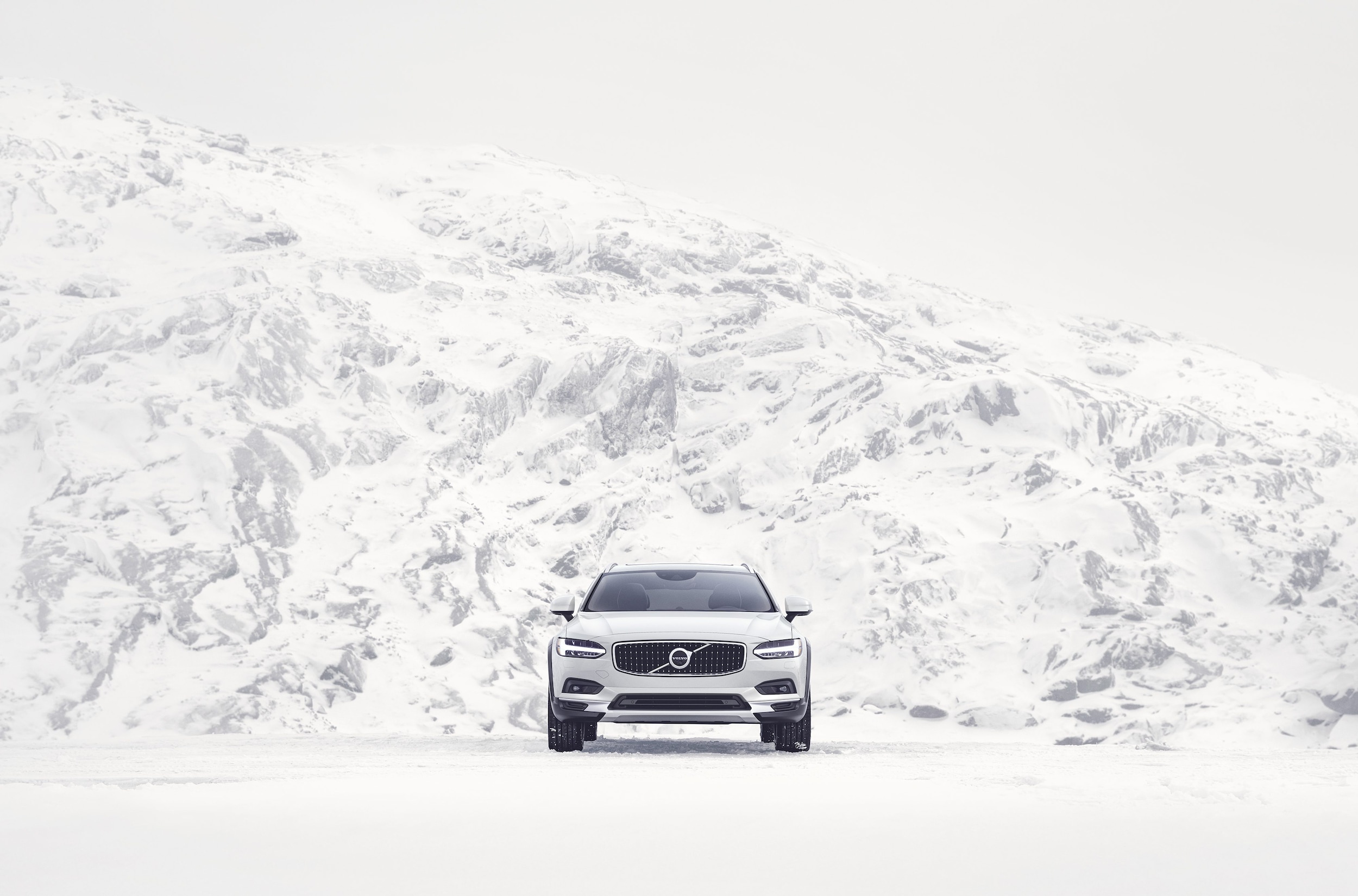 Parked White Car fron view in snow