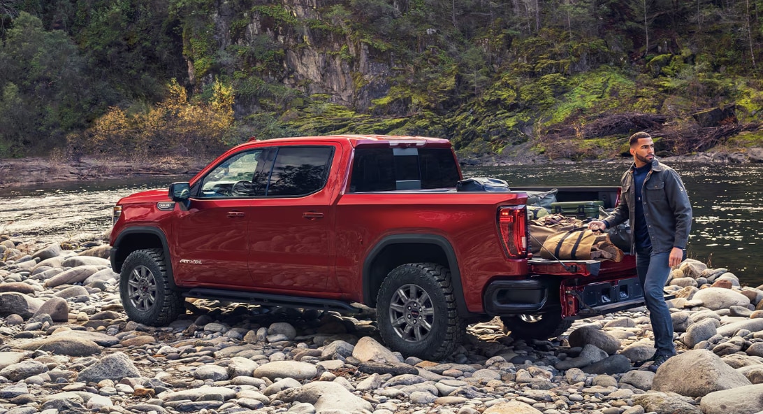 Red 2026 GMC Sierra 1500 off-road by creek
