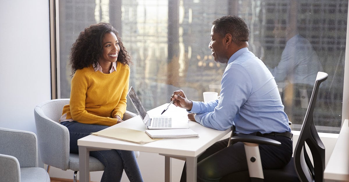 2 People talking at Desk