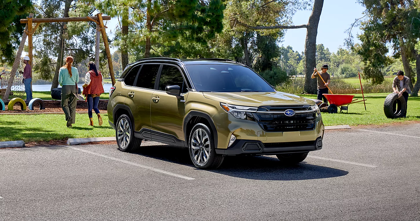 Gold Metallic 2025 Subaru Forester parked outside of a park.