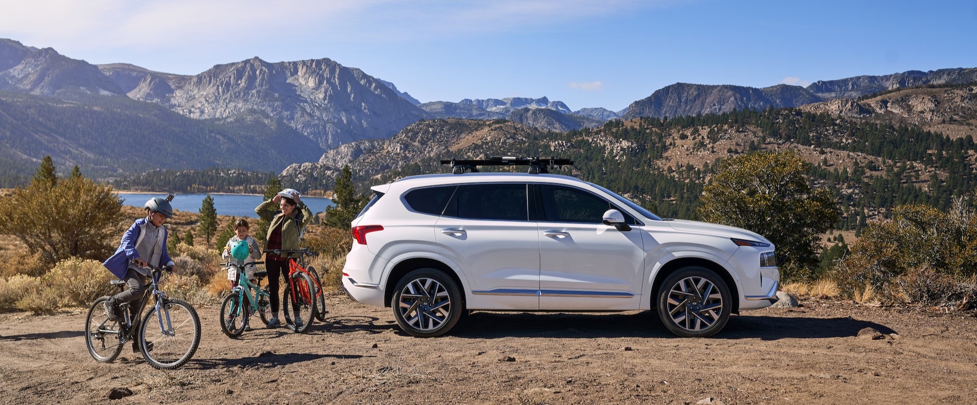 Hyundai Lifestyle Kds with their bikes near of a Hyundai SUV on the mountain