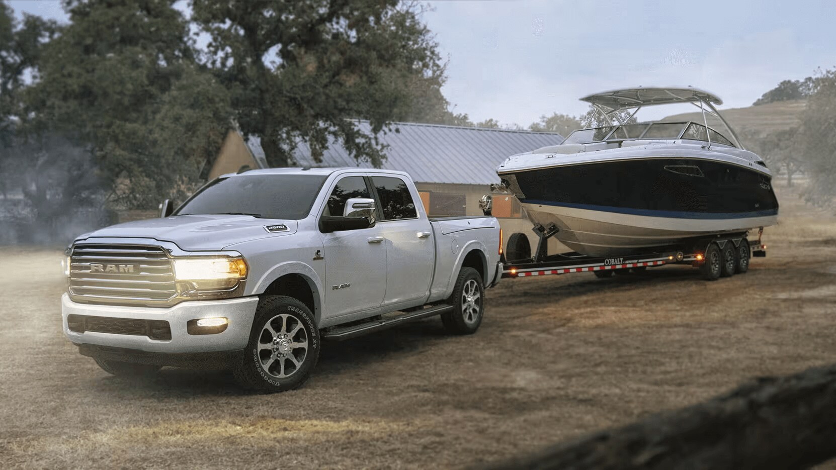 Exterior shot of a white Ram 2500 towing a speedboat.