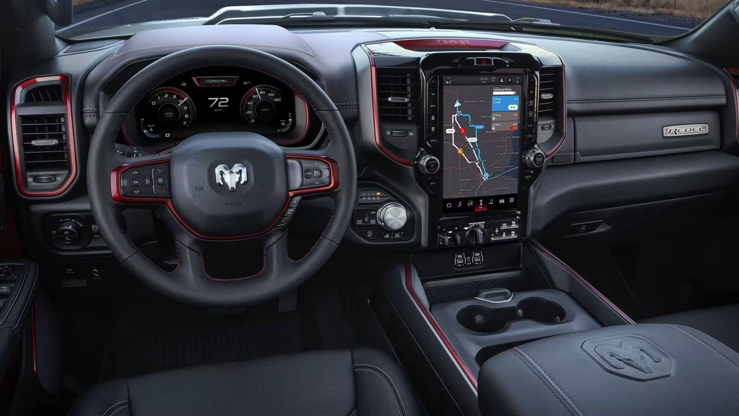 Interior shot of the 2023 Ram 1500 showing the steeering wheel and dashboard controls.