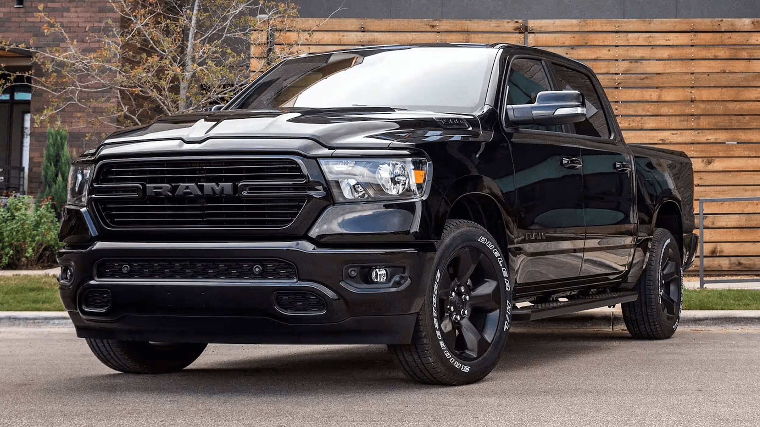 Exterior shot of a black Ram 1500 parked at an angle on a residential street so you can see the front of the truck.