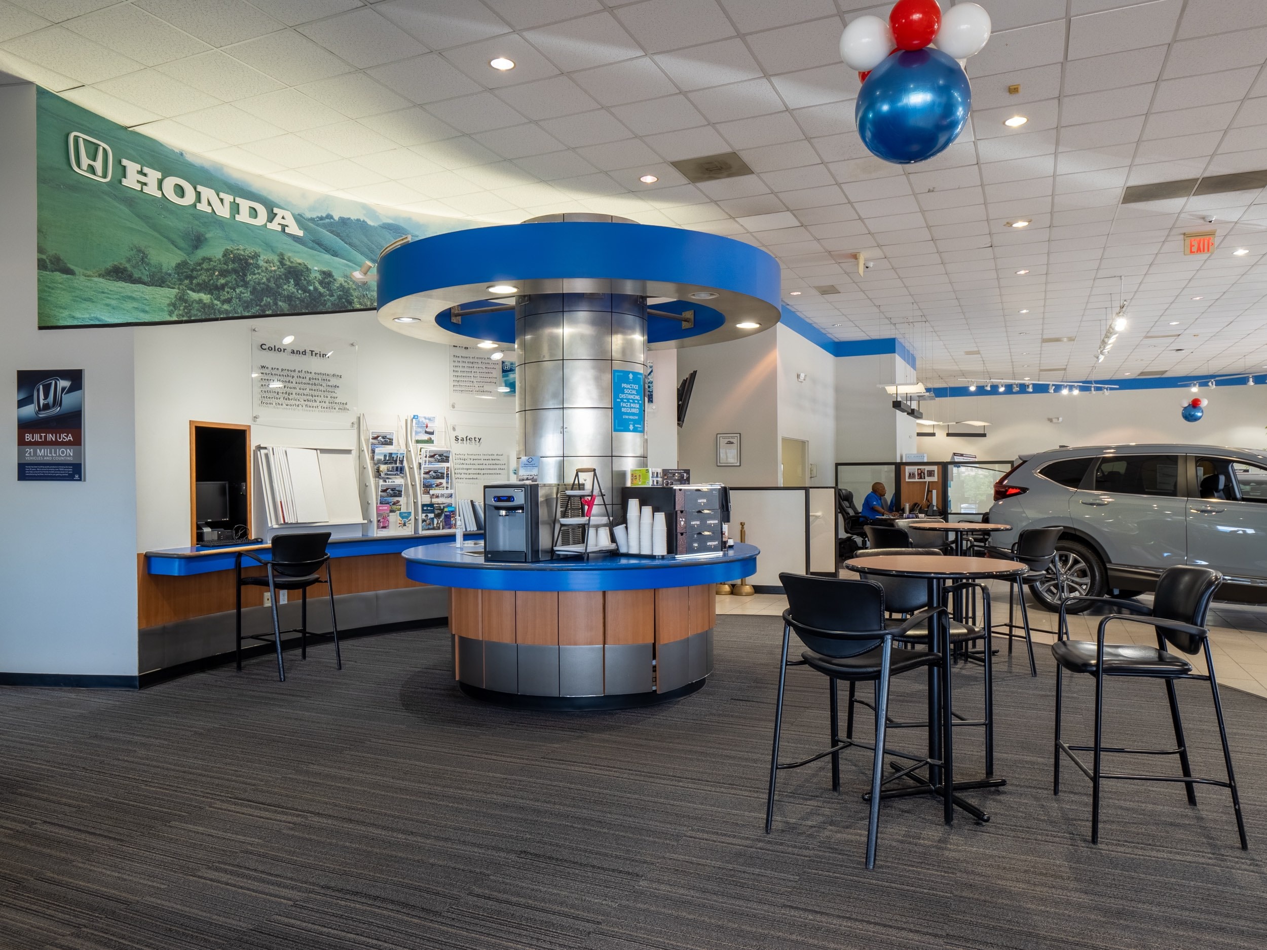 Interior view of AutoNation Honda 104, centered on a table with chairs.