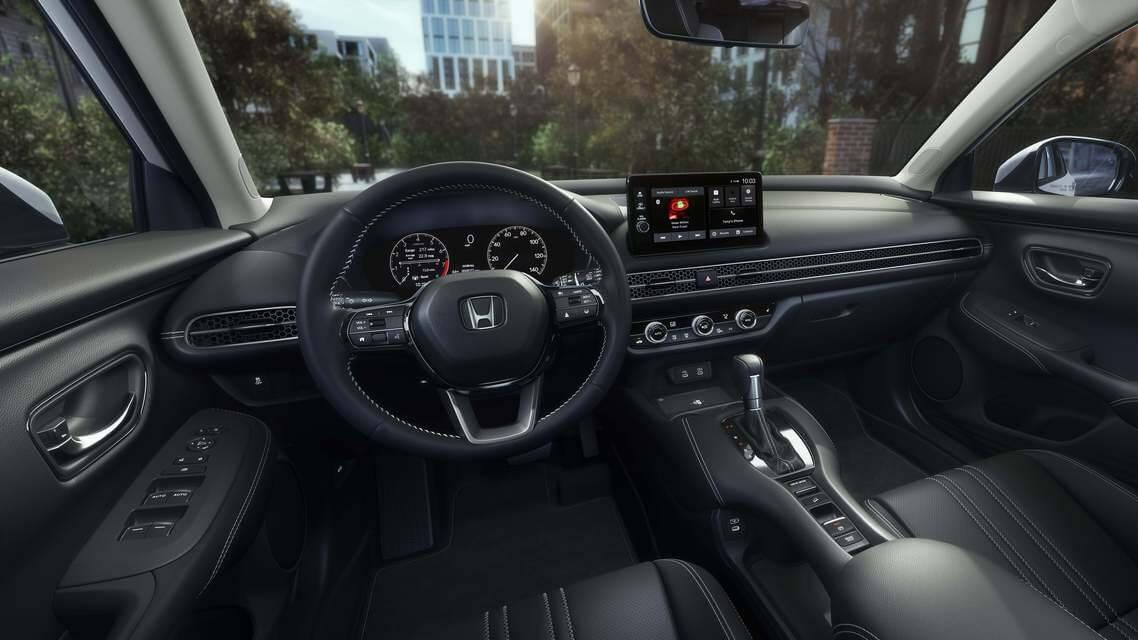  A picture from the driver's seat of an HR-V featuring the interior and a city outside the windows.