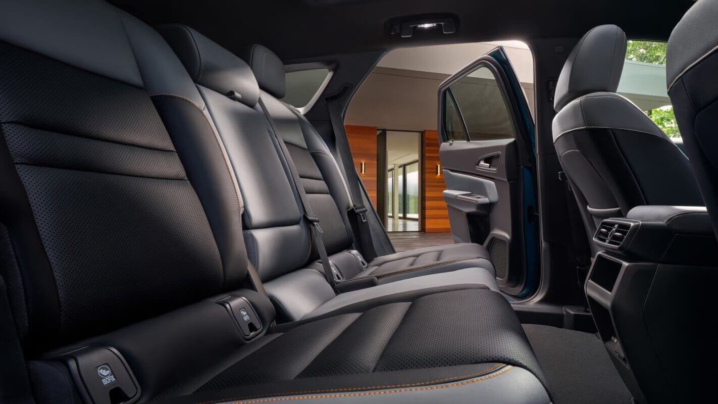  The back seats of a Honda Prologue with one of the doors opened.