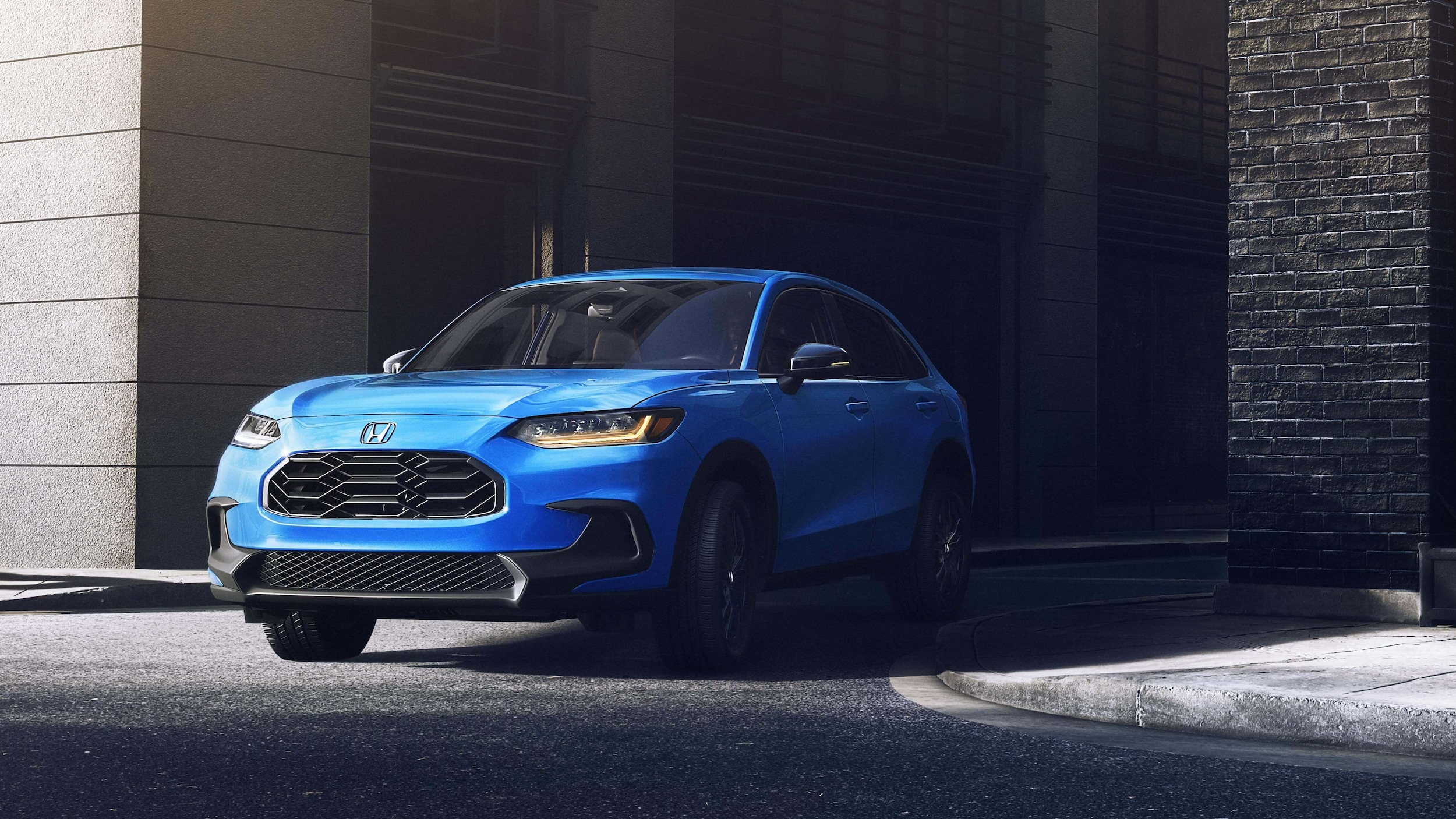 A blue Honda HR-V turning out of a city alleyway.