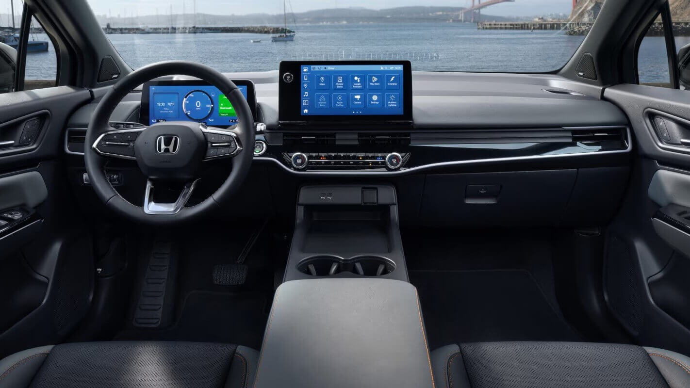  The steering wheel, center console display, and dashboard of a Honda Prologue.