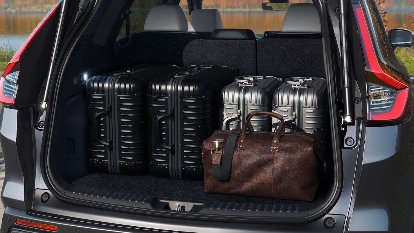  A collection of suitcases in the back of a Honda CR-V.