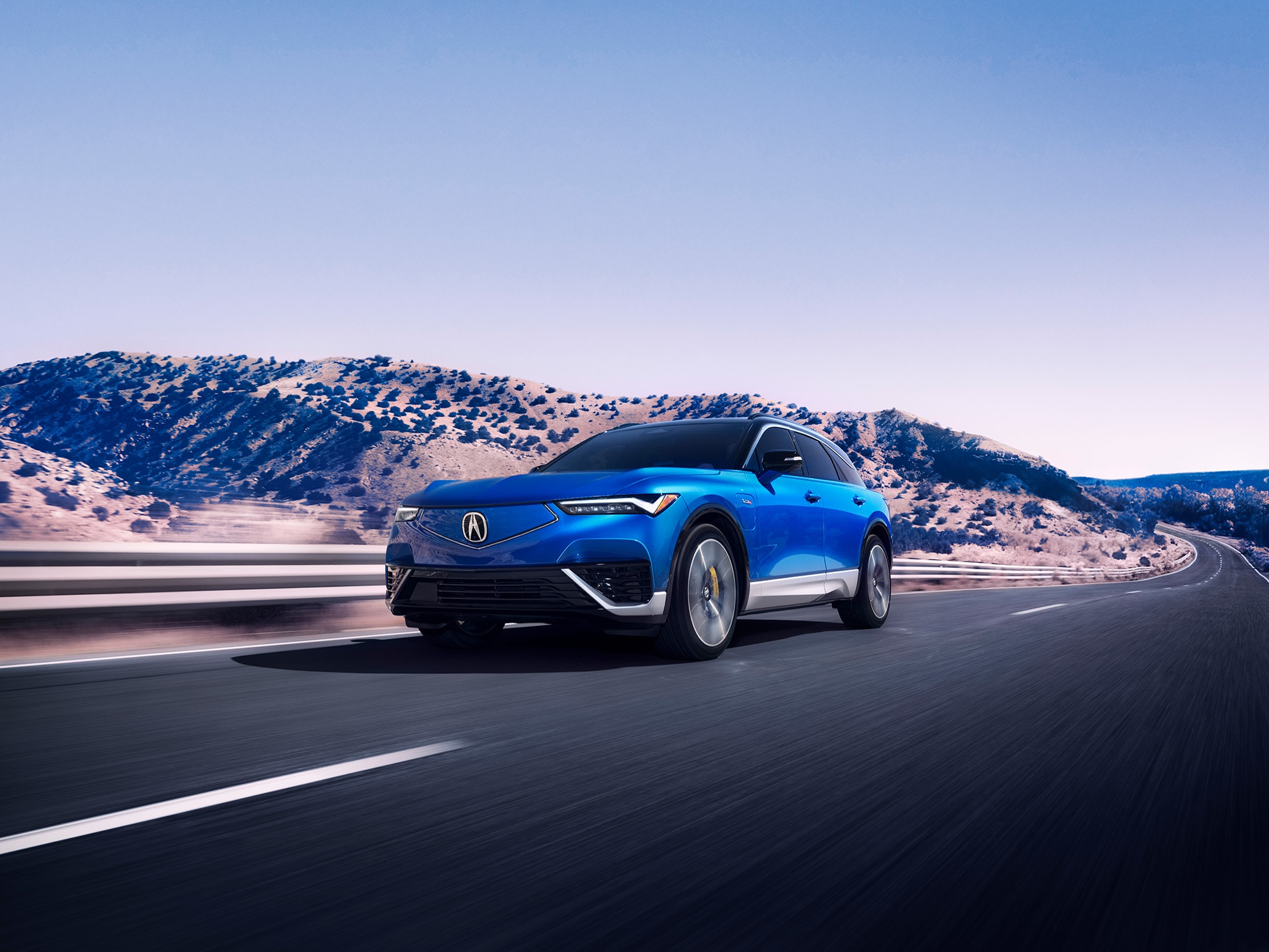 An Acura ZDX leased vehicle driving against a mountainscape