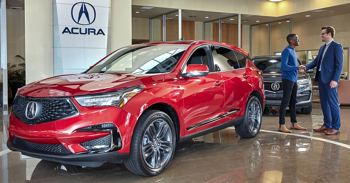 Customer speaking with a salesperson at an Acura dealership