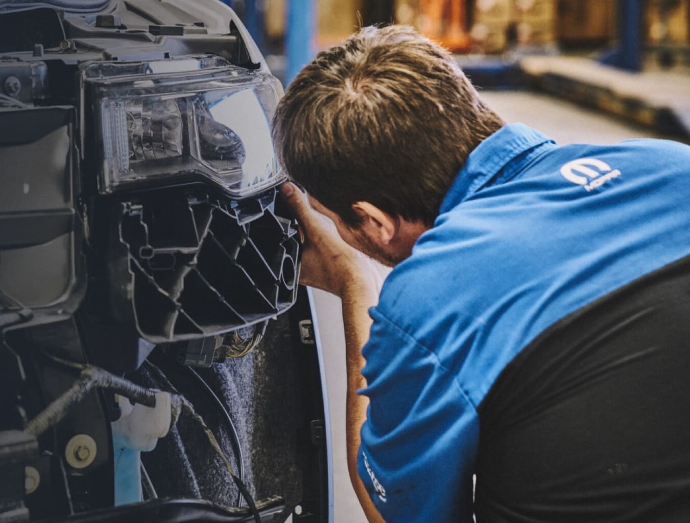 Certified Mopar collision technician performing auto body repair at Golling CDJR of Roseville