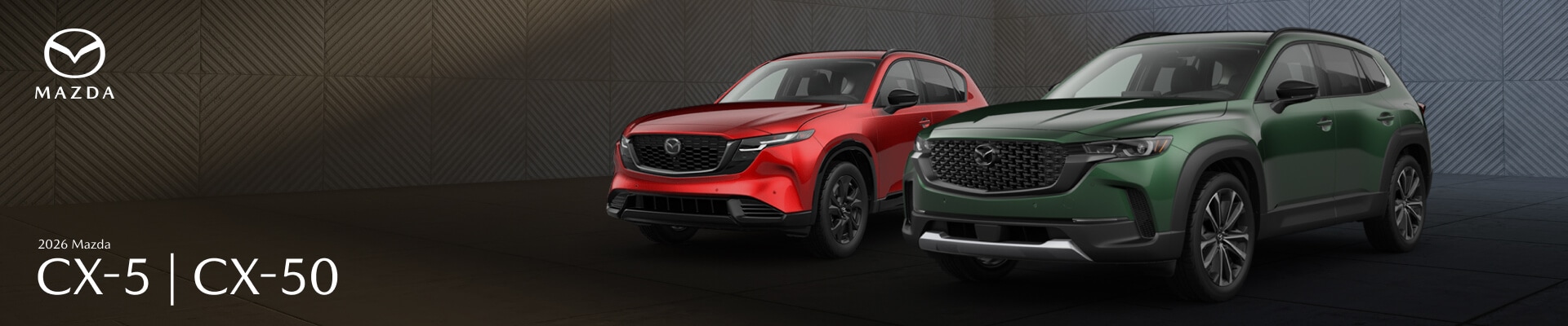 A red 2026 Mazda CX-5 and a green Mazda CX-50 parked side-by-side in a concrete building.