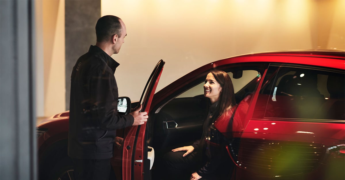 Customer speaking with a salesperson at a Mazda dealership