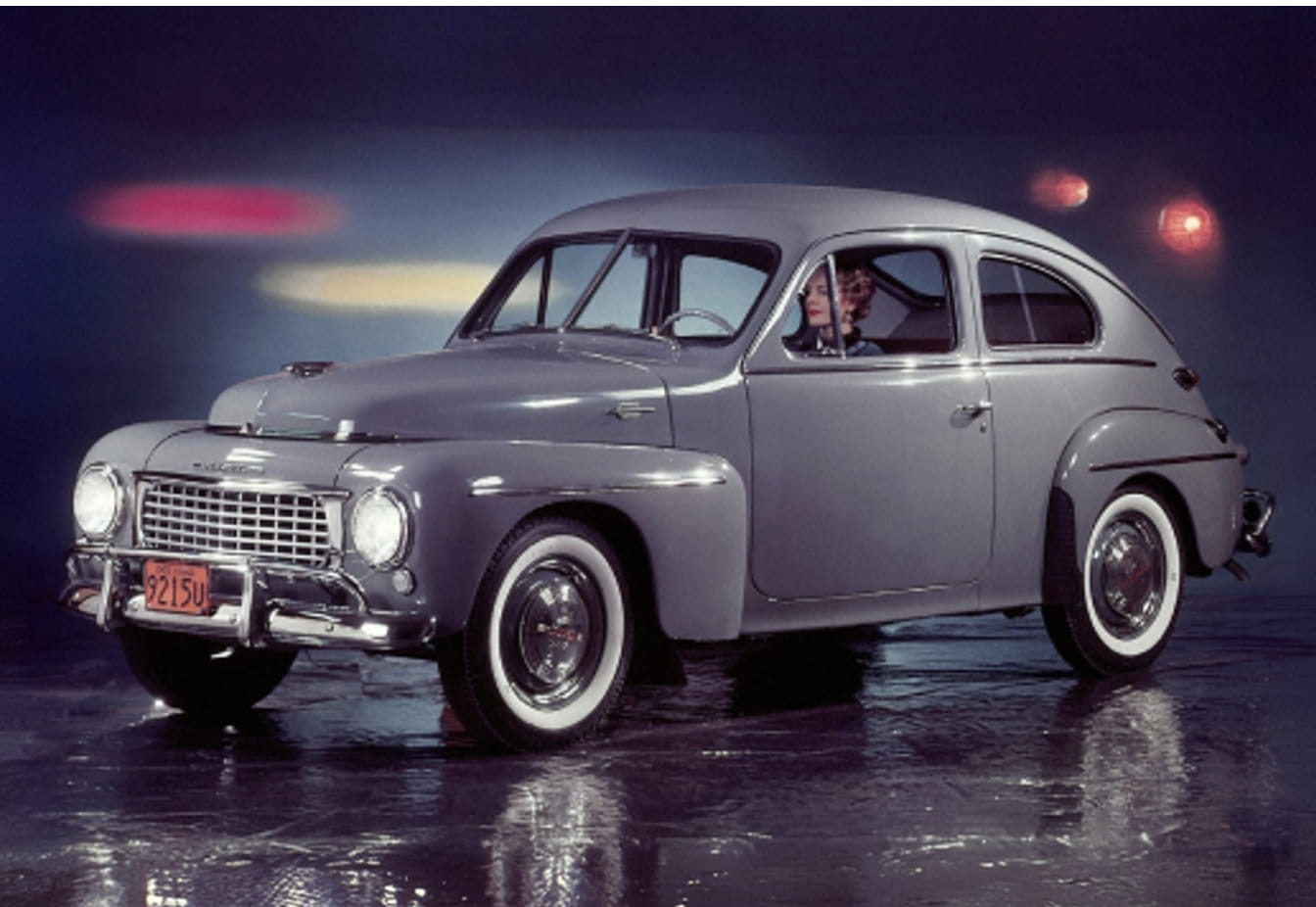 Vintage gray Volvo sedan shown from a front three-quarter angle with a driver inside
