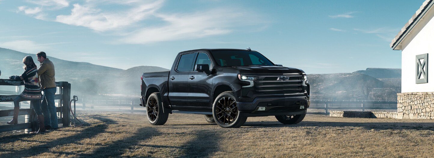 A black 2025 Chevrolet Silverado parked on a ranch or farm.