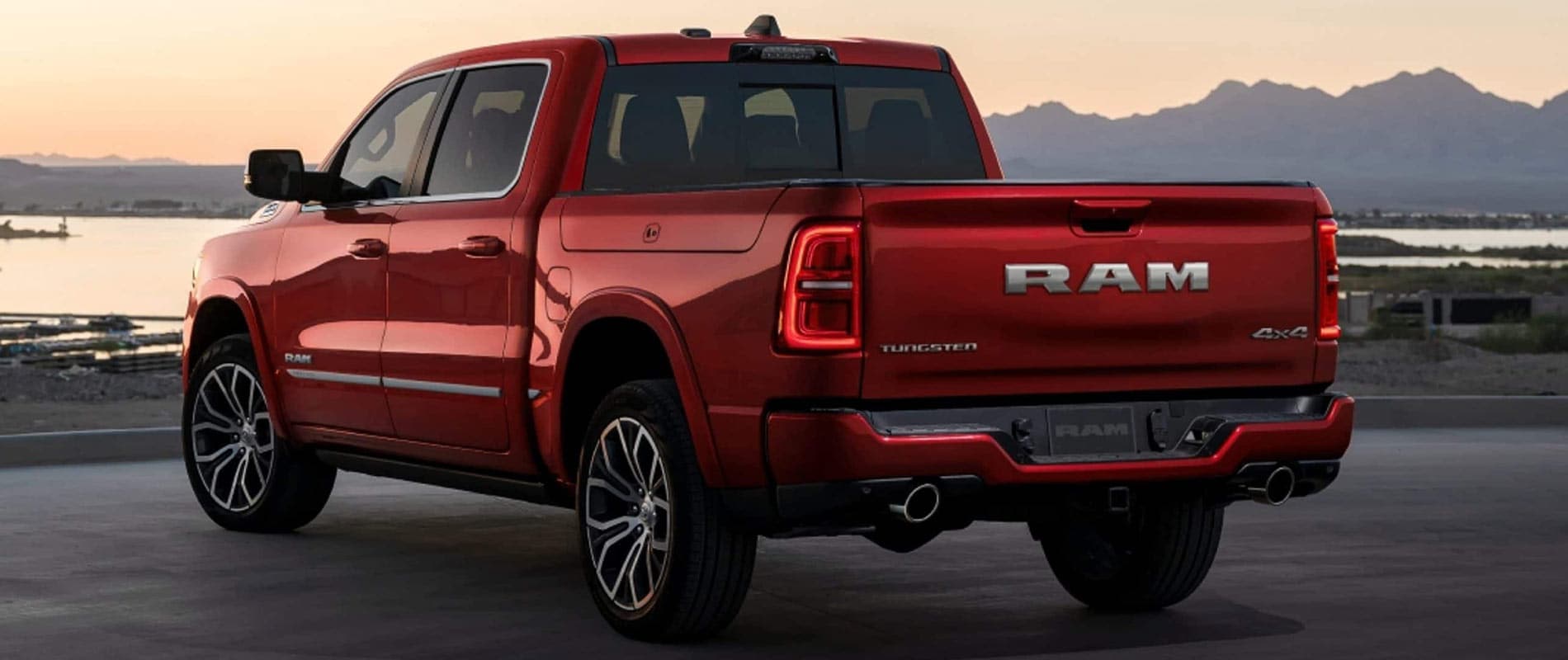 A red RAM 1500 parked near a pier.