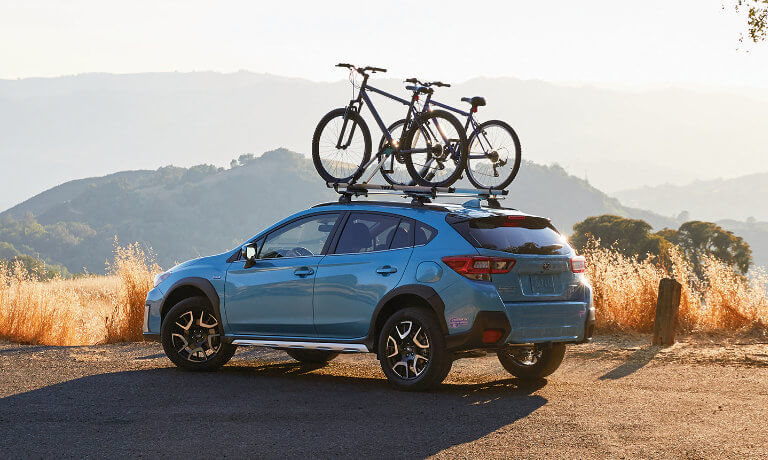 2020 Subaru Crosstrek parked by a cliff with bikes on the roof rack