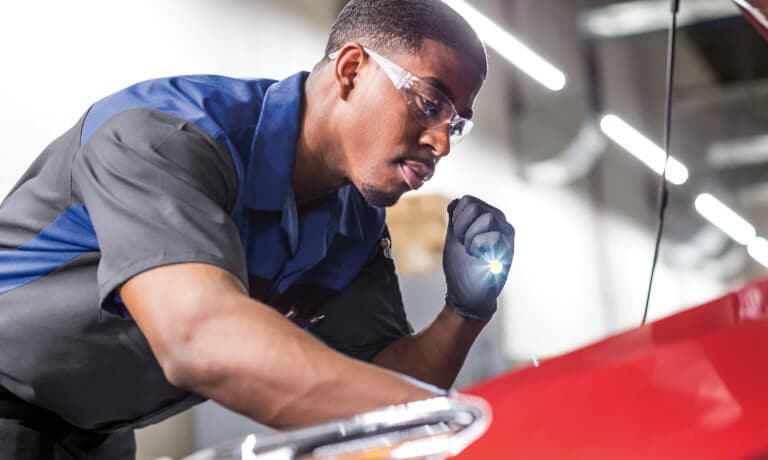 Subaru Service Tech Looking Under Hood