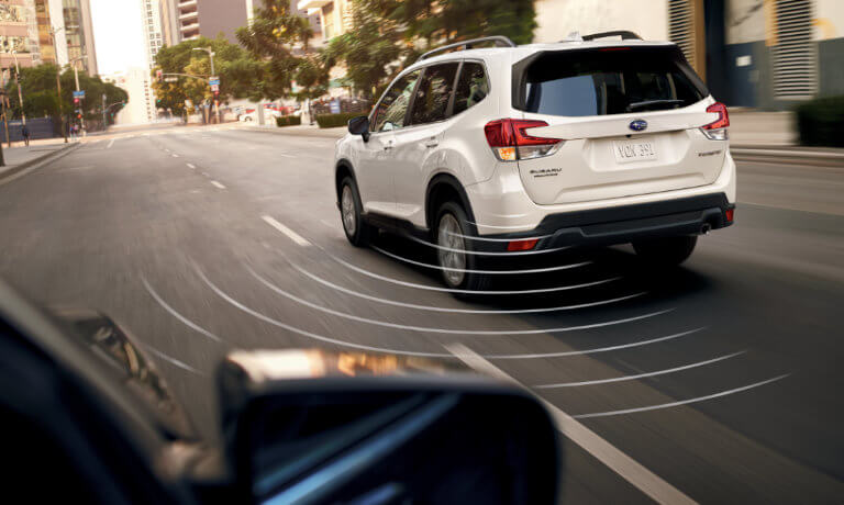 2020 Subaru Forester driving on city road with blind spot collision sensors