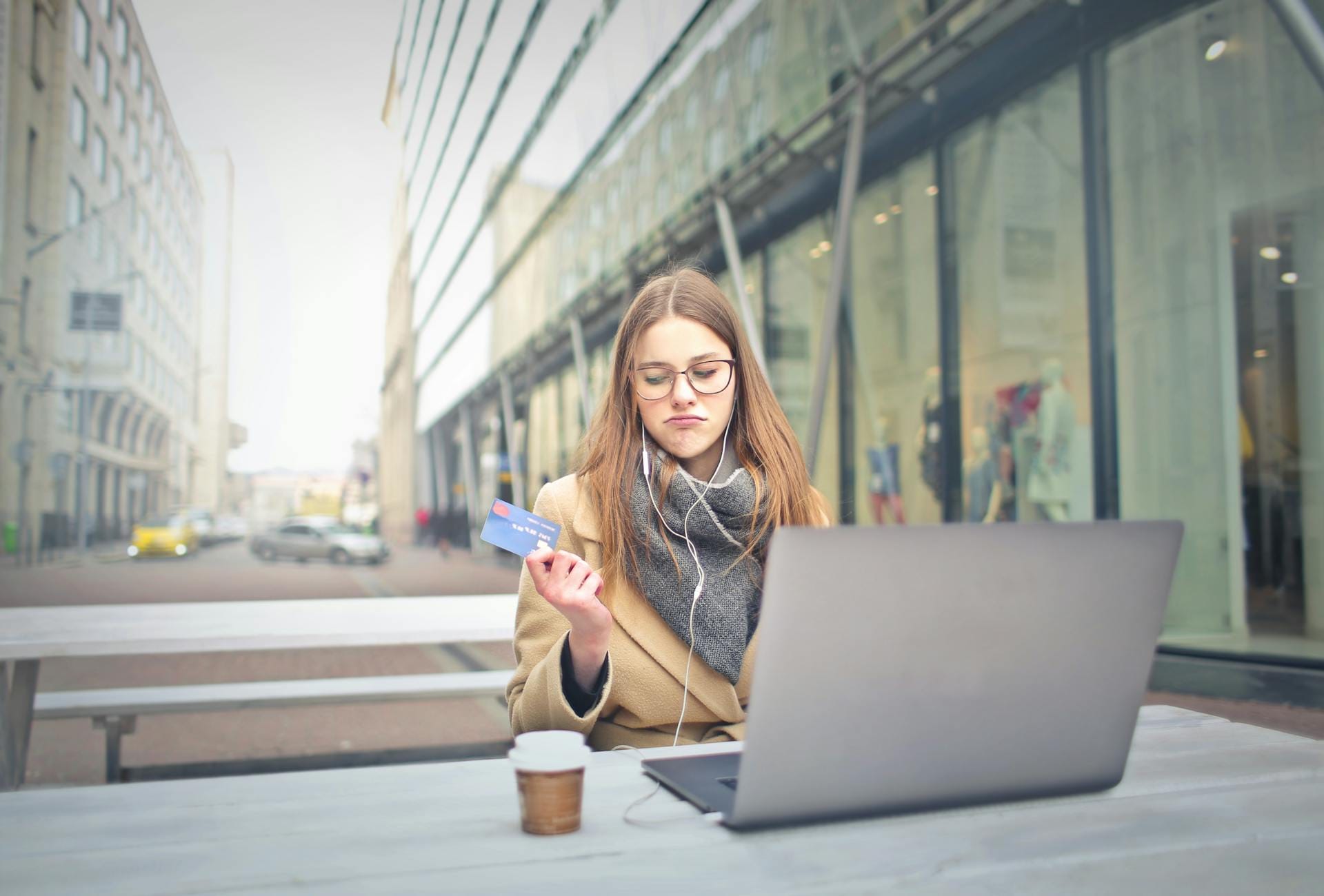 A young woman holding a credit card