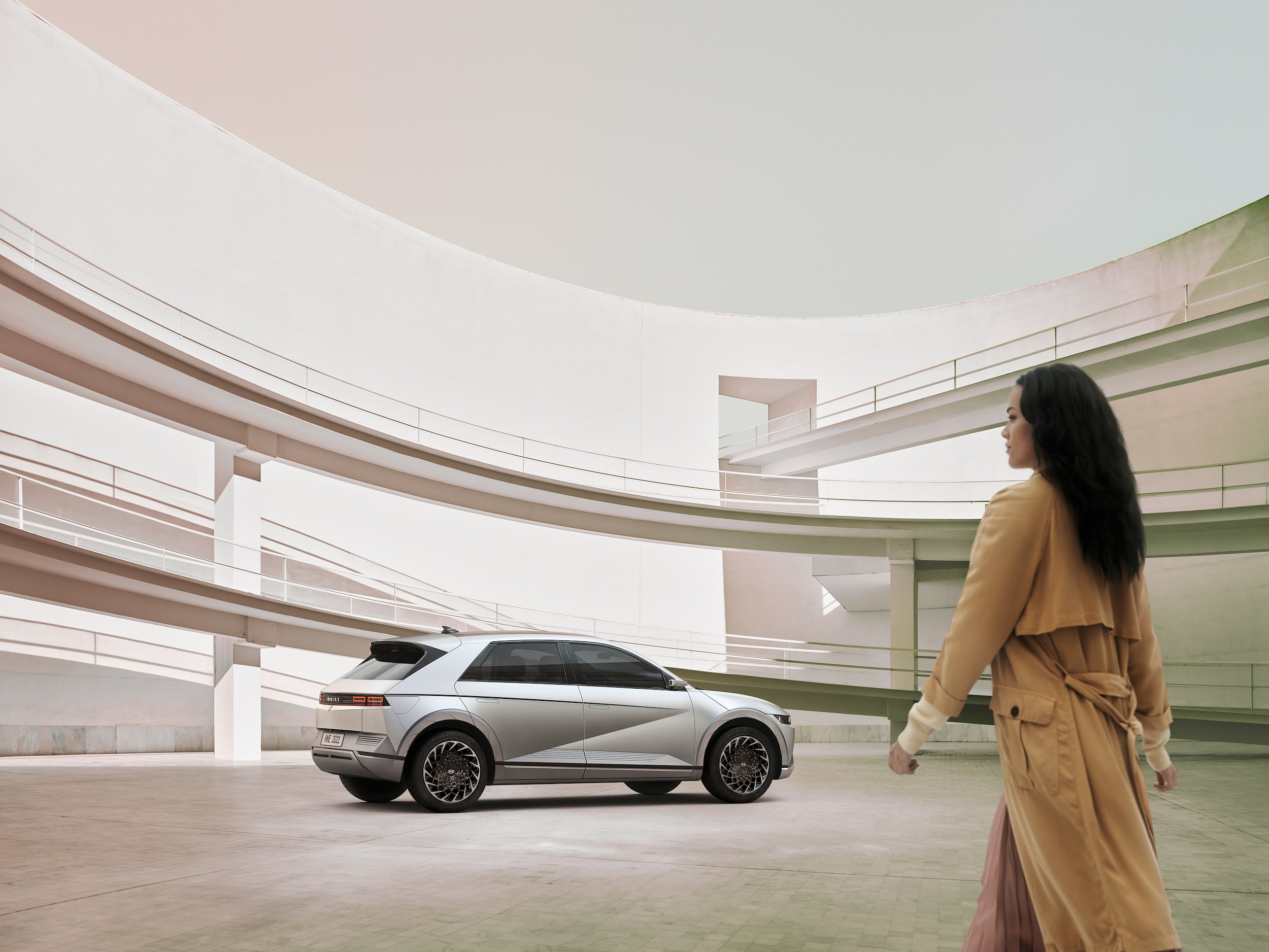 A woman walking toward a Hyundai