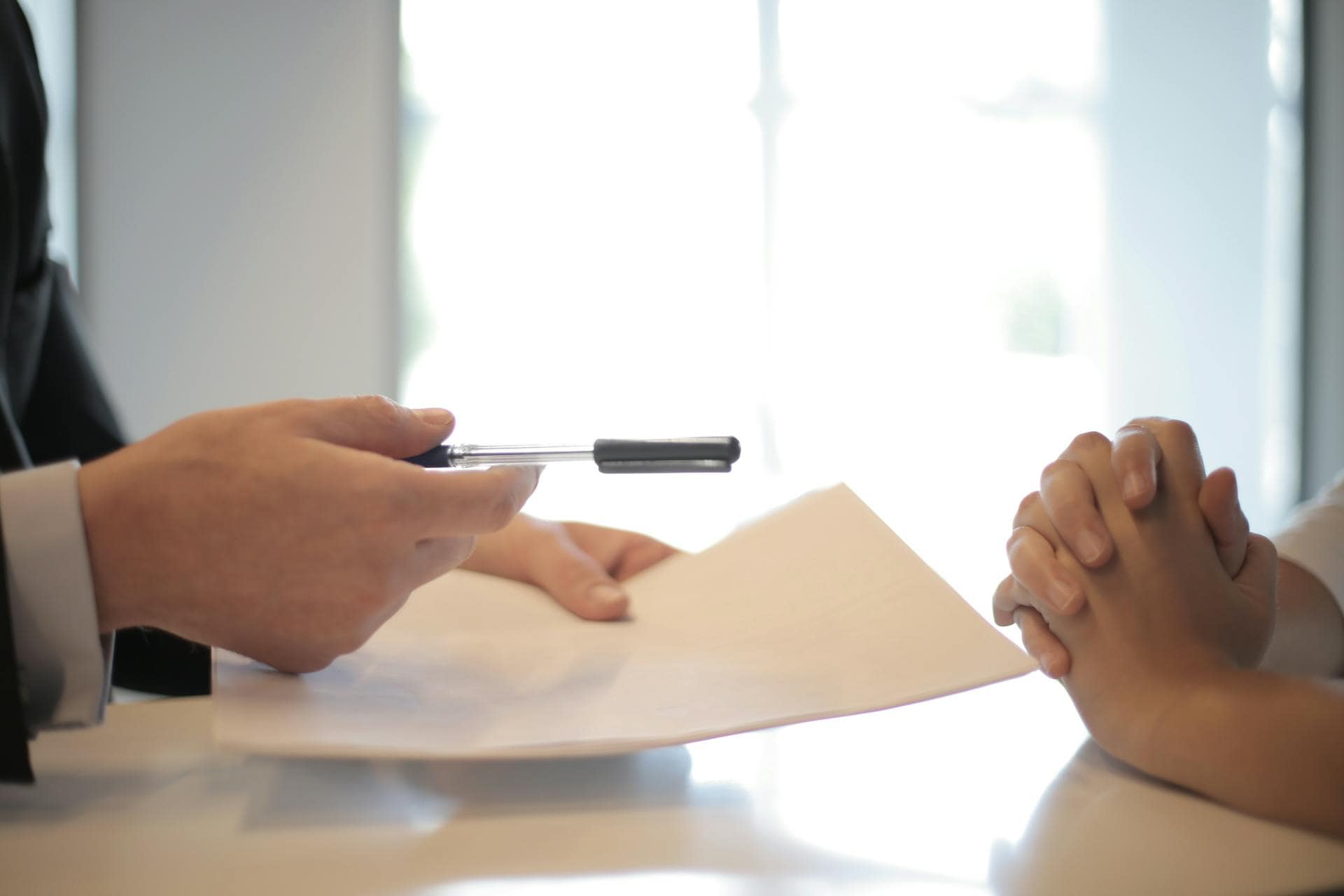 Two people at a desk with papers