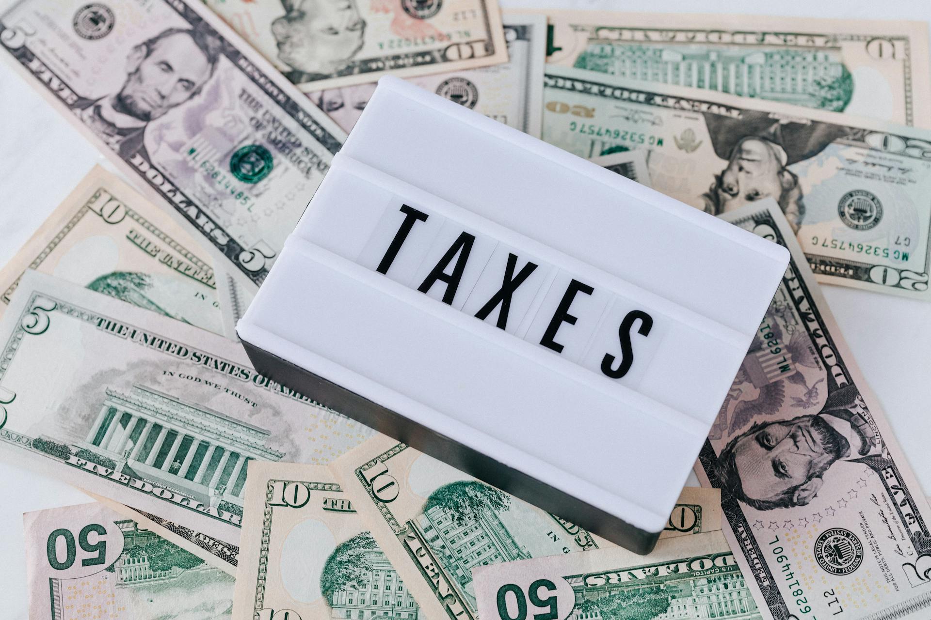 Taxes spelt out with money in the background