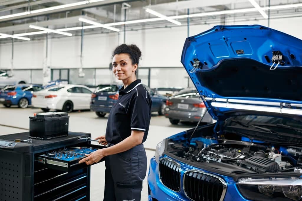A woman working on a bmw vehicle.