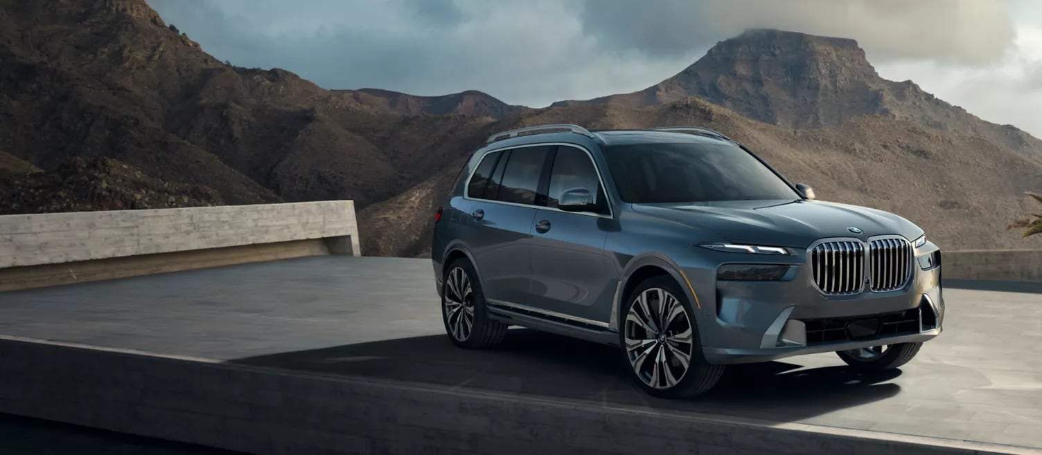 A bmw x7 driving on the road.