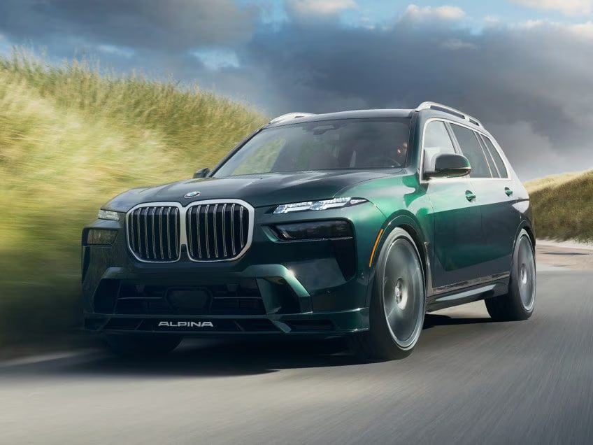 2027 bmw x7 alpina xb7 in green driving on a road