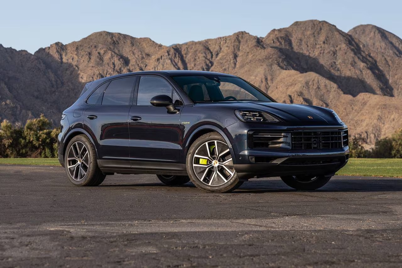 The 2026 Porsche Cayenne parked outside with a view of mountains in the back ground