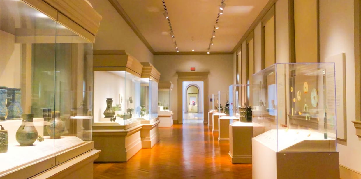 Museum gallery with glass display cases and artifacts.PNG