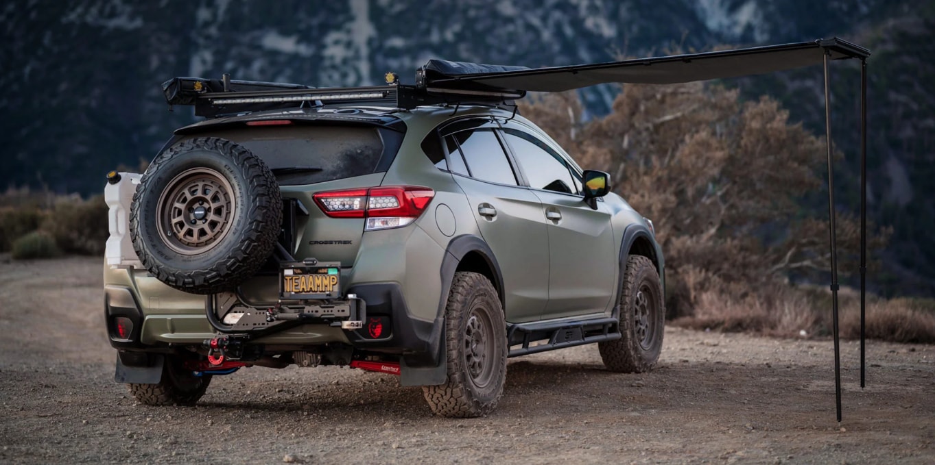 Overlanding vehicle parked on a dirt trail with an outdoor sunshade setup.png
