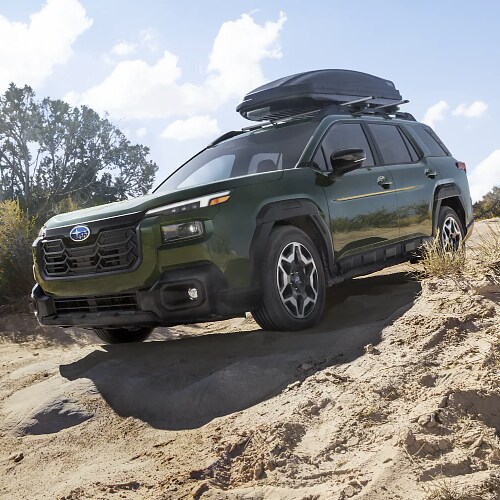 2026 Subaru Outback Touring shown in Deep Emerald Green Pearl with accessory equipment