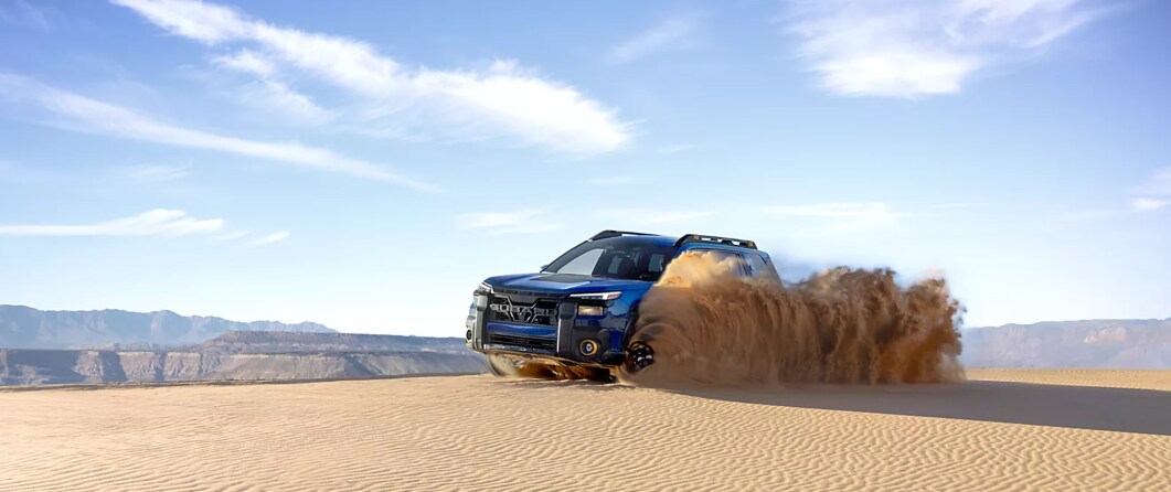 Blue%20Subaru%20driving%20on%20sand%20dunes.png