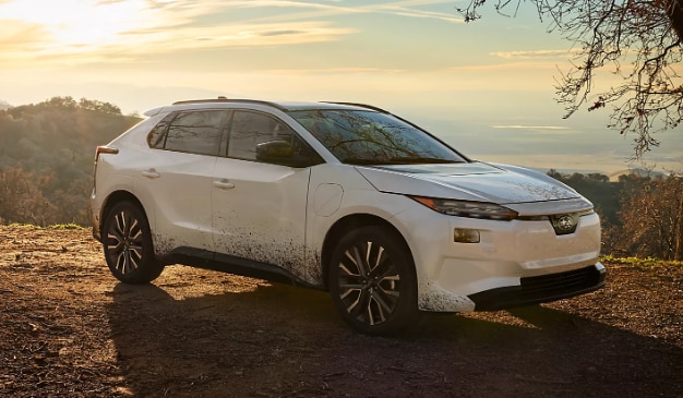 2026 Subaru Solterra parked on scenic overlook with mountain view