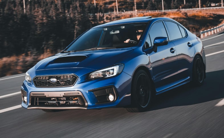 Blue Subaru performance vehicle running on street