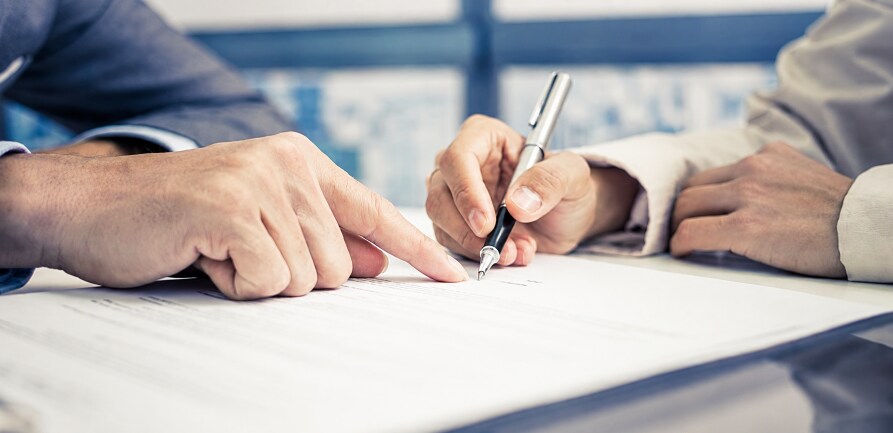 Customer%20signing%20auto%20financing%20paperwork%20at%20dealership.png