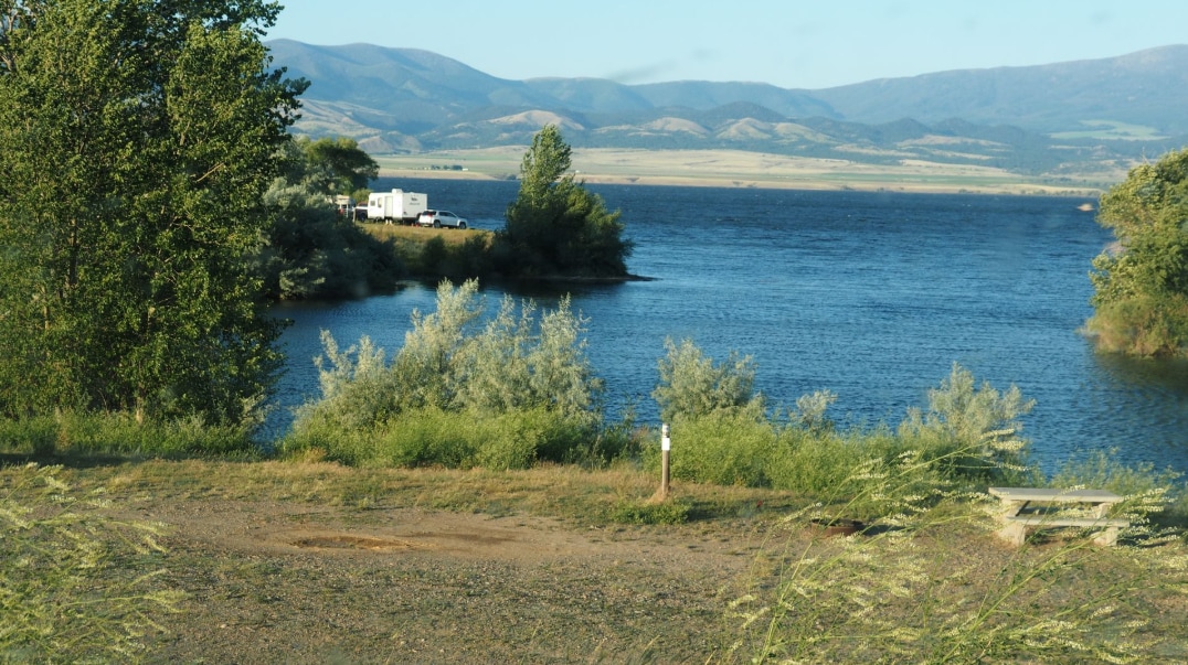 Sunny%20landscape%20of%20a%20lake%20and%20surrounding%20hills.png