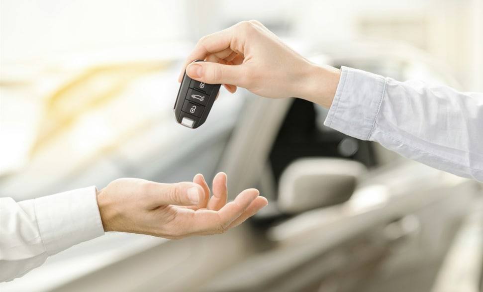 Customer receiving car keys during vehicle purchase