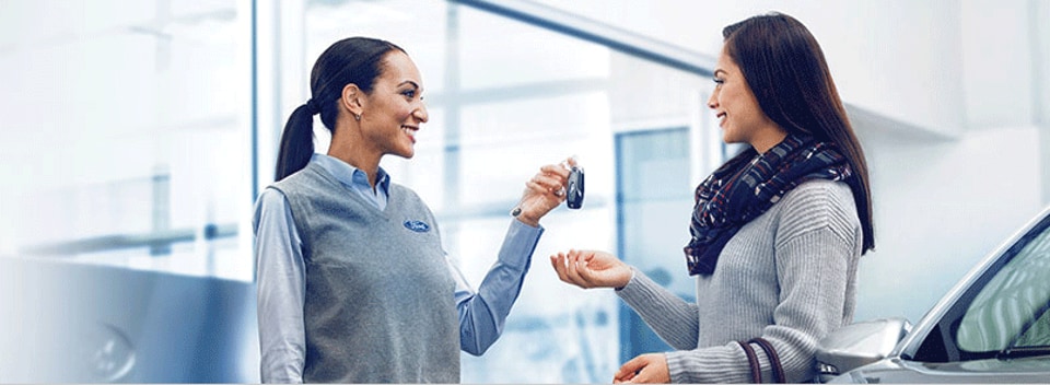 Ford Representative handing keys to a customer
