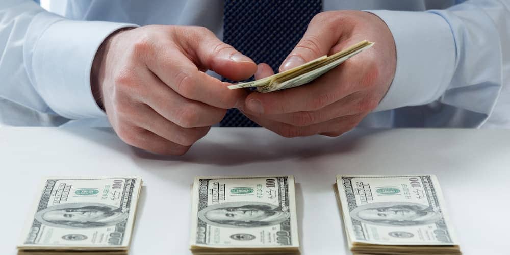 Hands Dealing Out Money