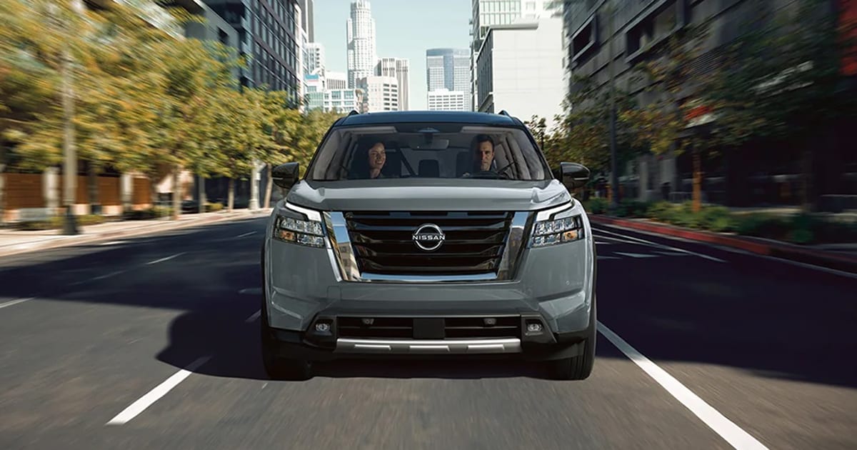 2024 Nissan Pathfinder Platinum driving through a city.