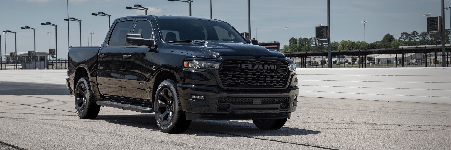 black Ram 1500 pickup truck driving on road