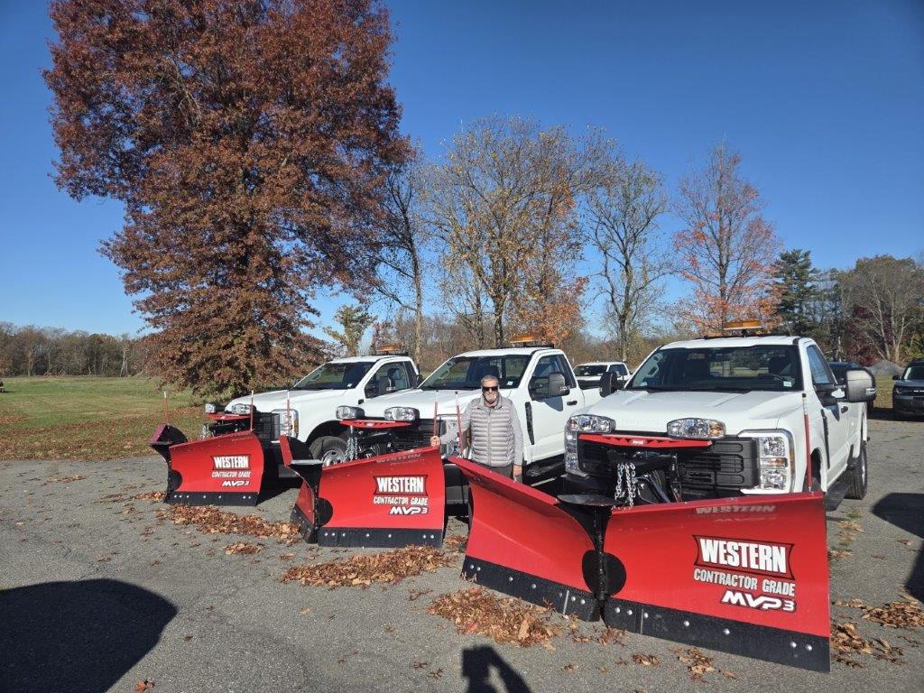 Front 3/4 shot of the 2025 Ford Transit parked in front of work site
