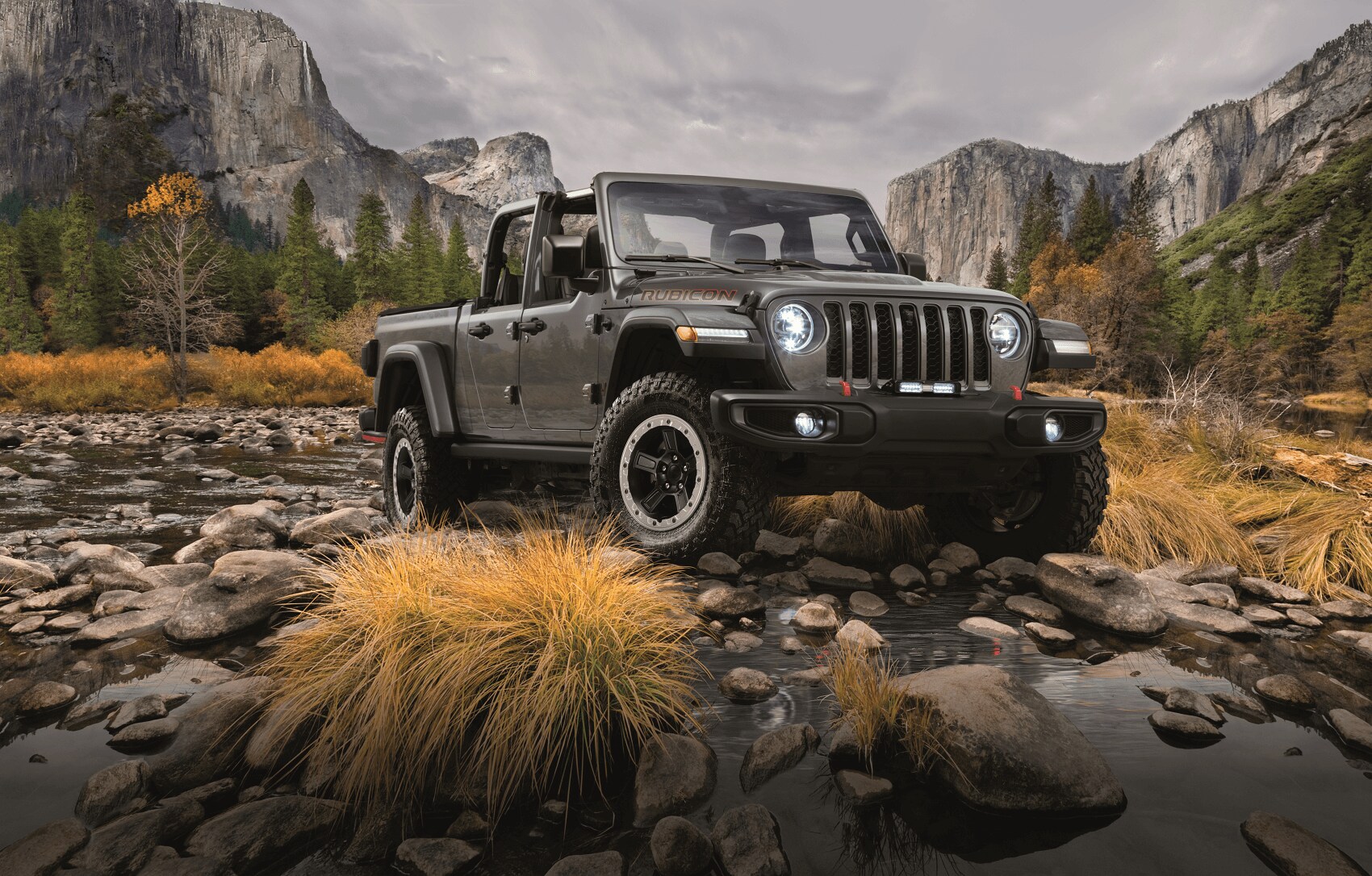 Jeep Gladiator driving through scenic campground - Jeep Dealer Peru IN