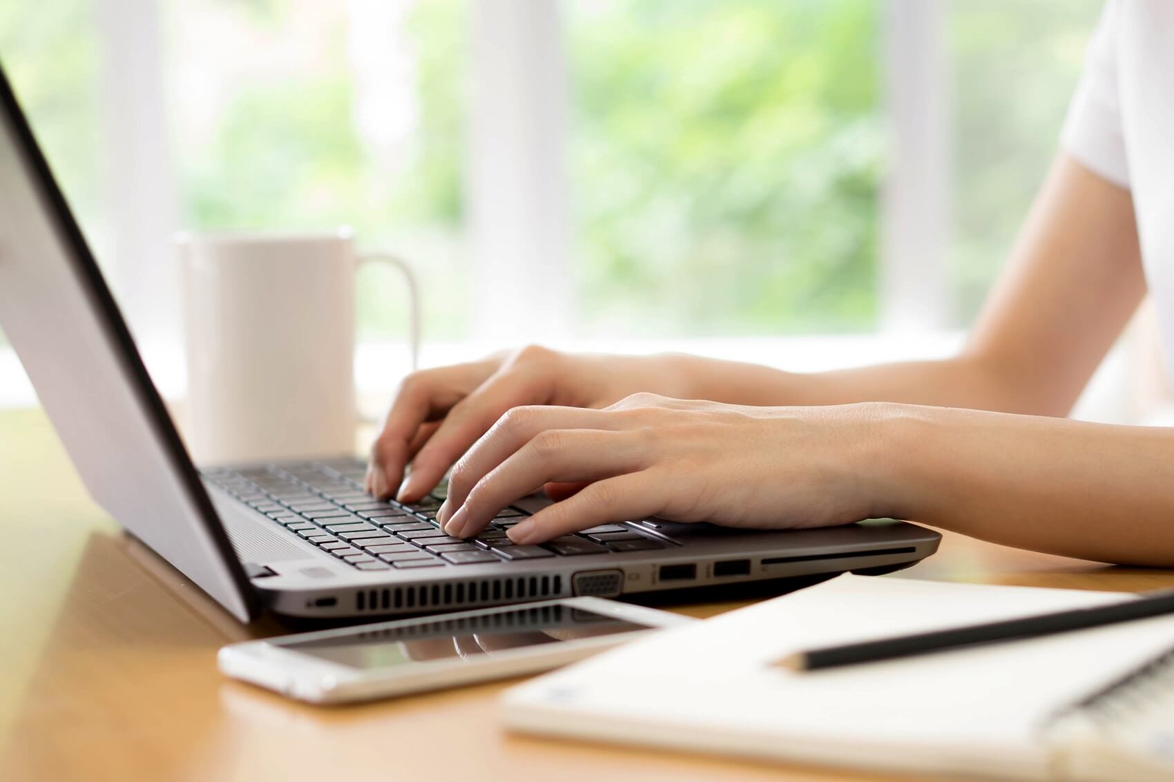 Woman typing on her laptop